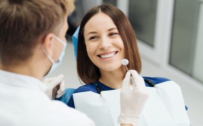 Dentist discussing with patient treatment plan Male Professional Dentist With Gloves And Mask And Discuss What The Treatment Will Look Like Of The Patient's Teeth. Discussion Of The Treatment Plan And Healthy Smile